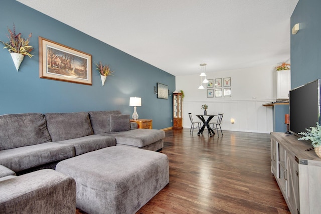 living area featuring wainscoting and dark wood-style flooring