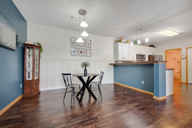 dining area with dark wood-type flooring