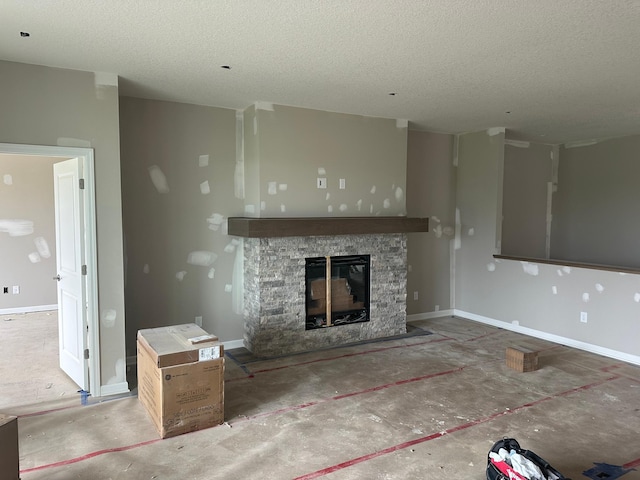 2063 Oakpointe Dr, Waconia, MN 55387 - unfurnished living room with a stone fireplace and a textured ceiling