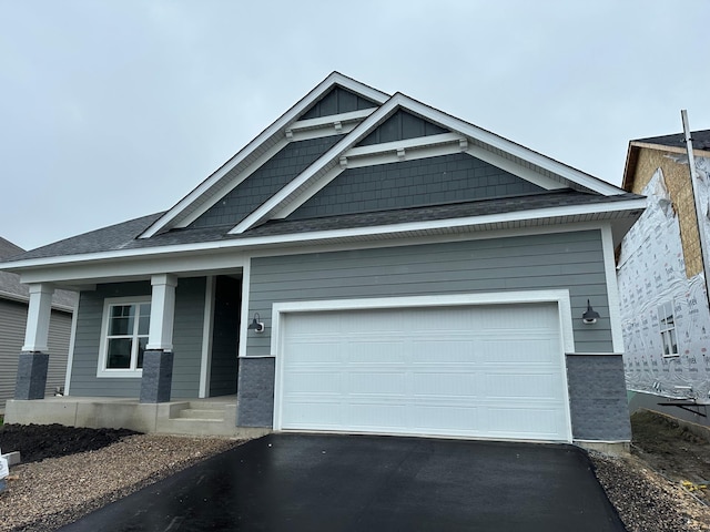 2063 Oakpointe Dr, Waconia, MN 55387 - craftsman inspired home with asphalt driveway, a porch, and a garage