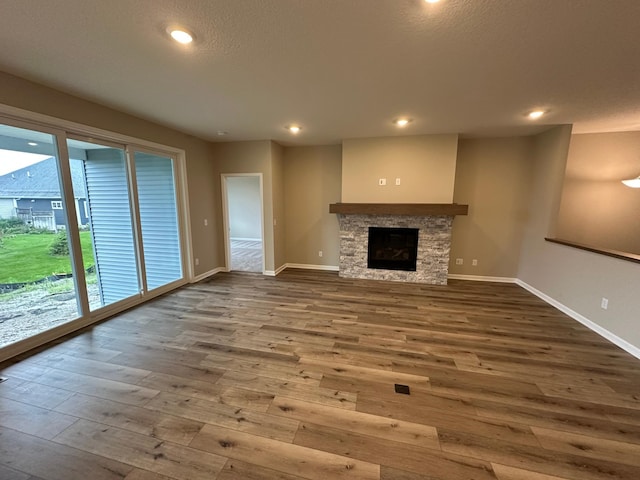 2063 Oakpointe Dr, Waconia, MN 55387 - unfurnished living room with wood finished floors, recessed lighting, and a fireplace