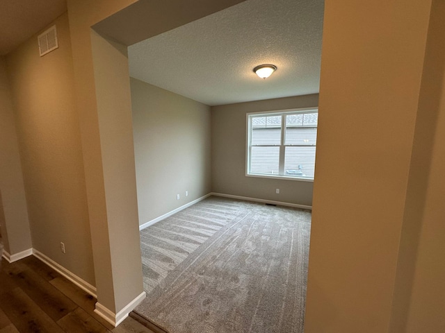 2063 Oakpointe Dr, Waconia, MN 55387 - spare room featuring baseboards and a textured ceiling