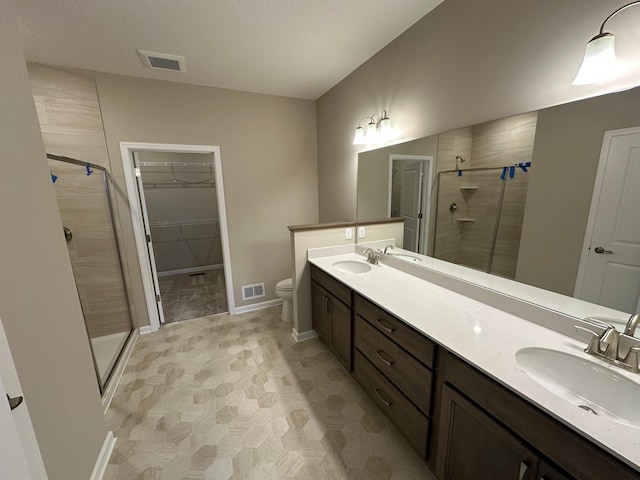 2063 Oakpointe Dr, Waconia, MN 55387 - bathroom featuring a stall shower, double vanity, and a spacious closet