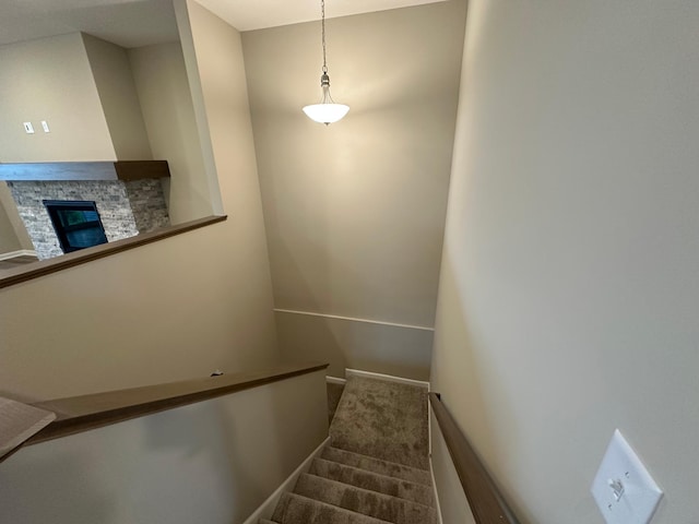 2063 Oakpointe Dr, Waconia, MN 55387 - staircase featuring a stone fireplace and carpet flooring