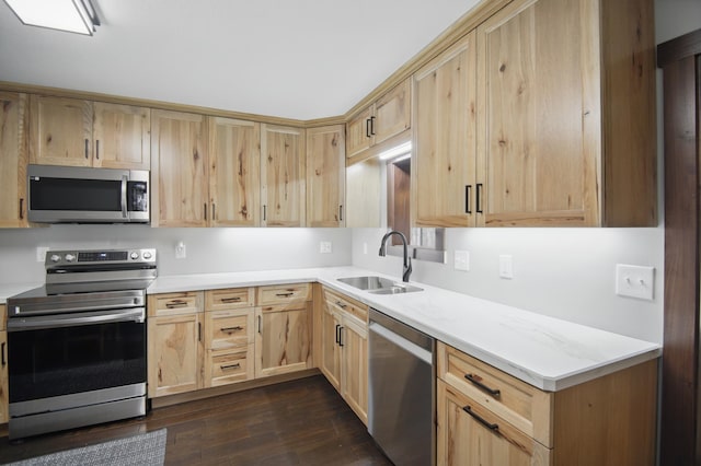 235 3rd St NE, Blooming Prairie, MN 55917 - kitchen with dark wood finished floors, light brown cabinetry, light countertops, a sink, and appliances with stainless steel finishes