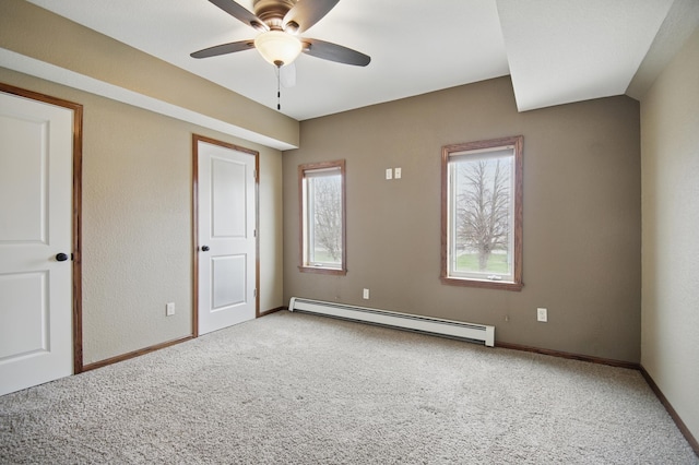 235 3rd St NE, Blooming Prairie, MN 55917 - unfurnished bedroom featuring baseboards, carpet, and baseboard heating