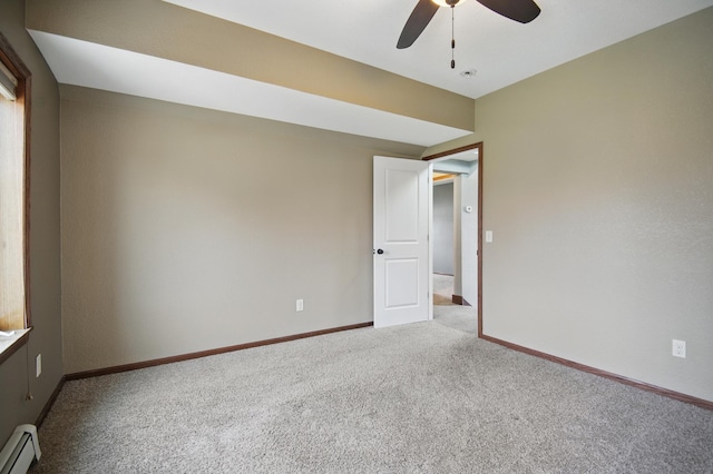 235 3rd St NE, Blooming Prairie, MN 55917 - carpeted spare room featuring baseboard heating, baseboards, and a ceiling fan
