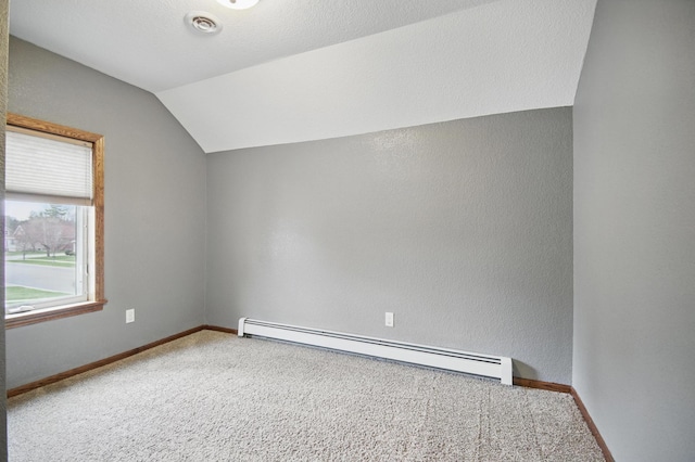 235 3rd St NE, Blooming Prairie, MN 55917 - additional living space featuring vaulted ceiling, baseboards, carpet floors, and a baseboard radiator