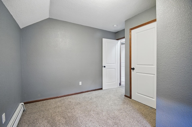 235 3rd St NE, Blooming Prairie, MN 55917 - carpeted spare room featuring a baseboard heating unit, a textured wall, a textured ceiling, and baseboards