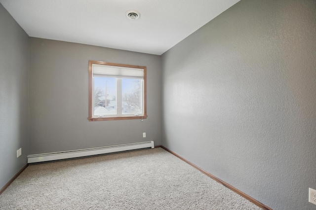 235 3rd St NE, Blooming Prairie, MN 55917 - unfurnished room with visible vents, baseboards, carpet flooring, and a baseboard radiator
