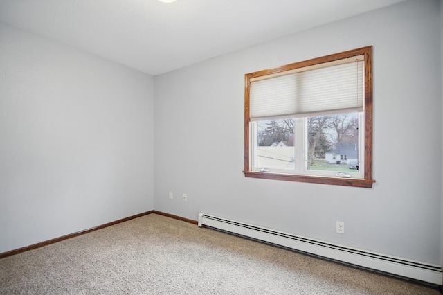235 3rd St NE, Blooming Prairie, MN 55917 - spare room featuring baseboards, carpet floors, and a baseboard radiator