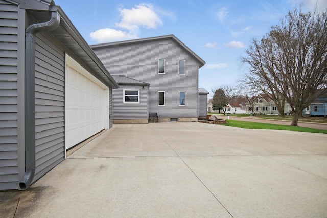 235 3rd St NE, Blooming Prairie, MN 55917 - back of house with concrete driveway and a garage