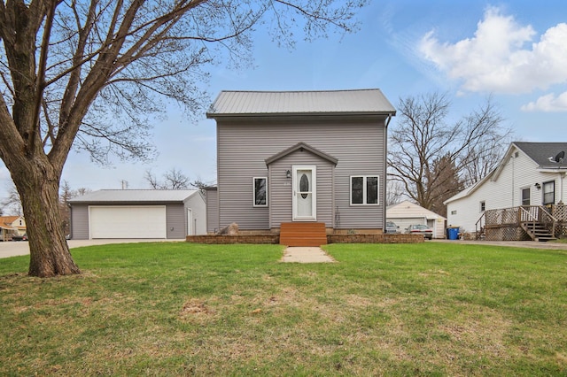 235 3rd St NE, Blooming Prairie, MN 55917 - view of front facade featuring an outdoor structure, a front yard, metal roof, and a garage
