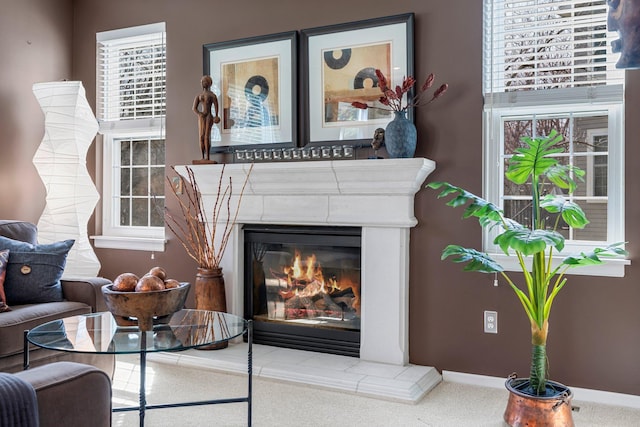 room details featuring carpet, a tiled fireplace, and baseboards