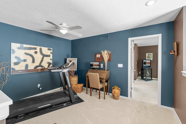 exercise room with a textured ceiling, ceiling fan, carpet floors, baseboards, and visible vents