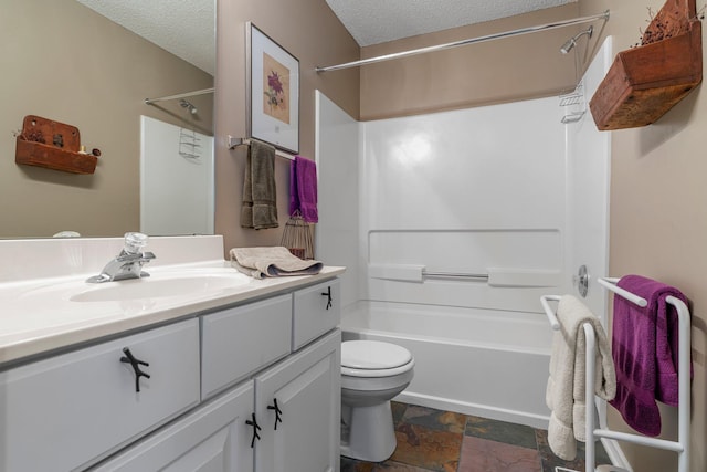 bathroom with a textured ceiling, stone tile floors, vanity, tub / shower combination, and toilet