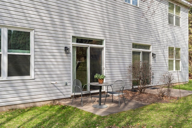 back of house featuring a yard and a patio