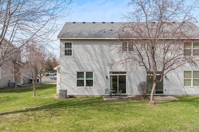back of house featuring a patio area, central AC unit, a yard, and a shingled roof