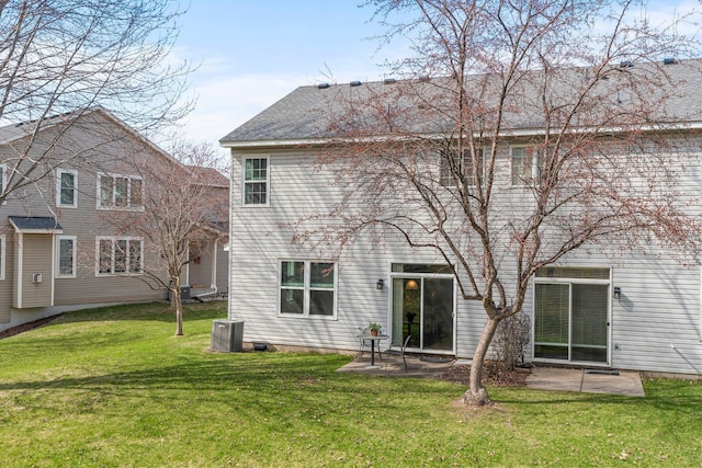 back of property featuring a patio area and a yard
