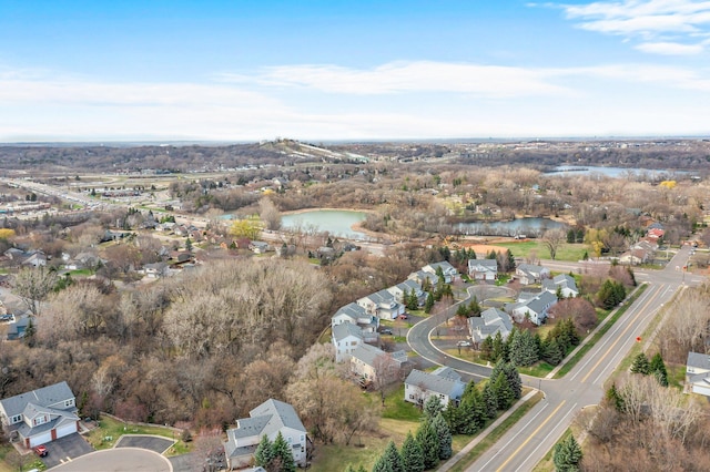 drone / aerial view featuring a residential view and a water view