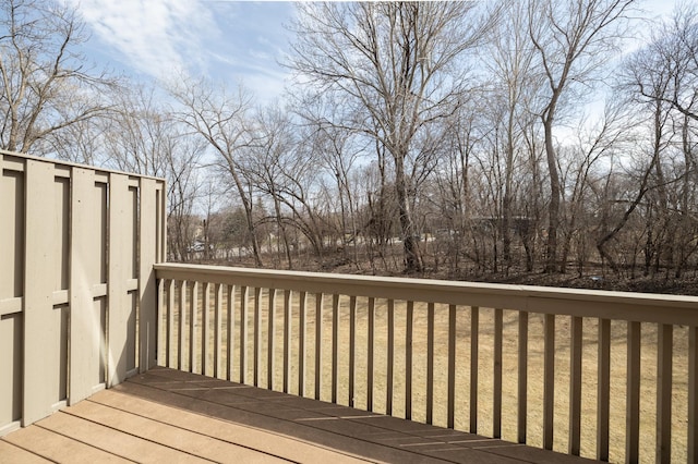wooden deck featuring a lawn