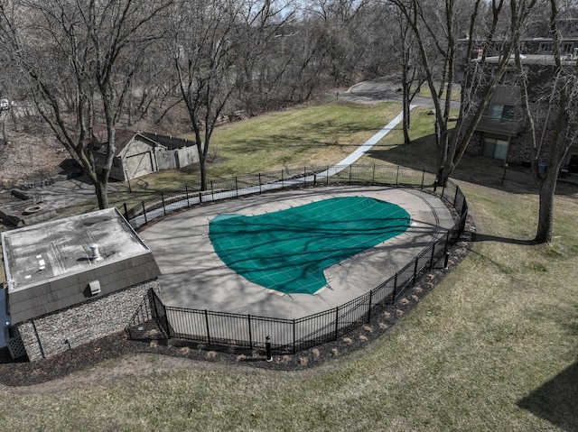 view of pool featuring fence and a yard