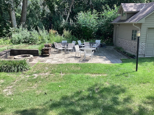 view of yard with a patio area and an outdoor fire pit