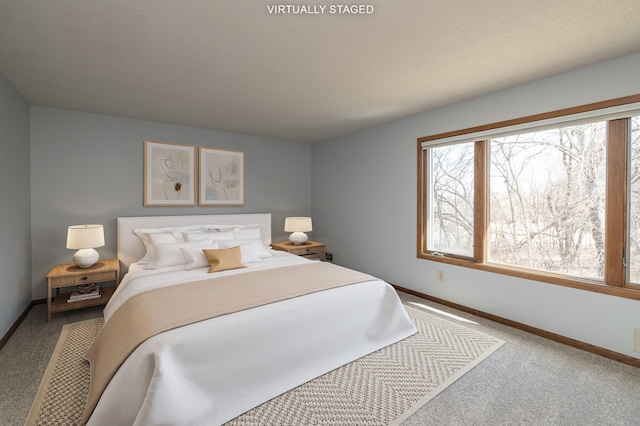 carpeted bedroom with baseboards and multiple windows