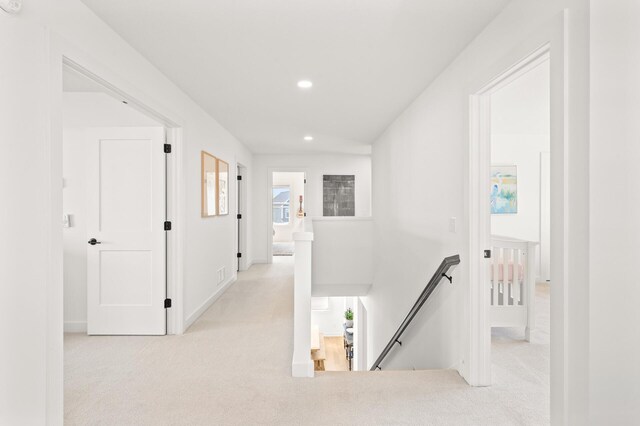 4429 Arbor Dr, Woodbury, MN 55129 - hall with an upstairs landing, light carpet, recessed lighting, and baseboards