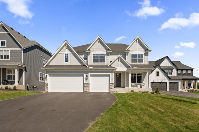 4429 Arbor Dr, Woodbury, MN 55129 - view of front facade featuring board and batten siding, driveway, stone siding, and a front lawn
