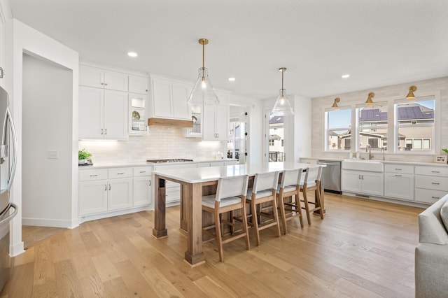 4429 Arbor Dr, Woodbury, MN 55129 - kitchen with appliances with stainless steel finishes, white cabinets, light countertops, and recessed lighting