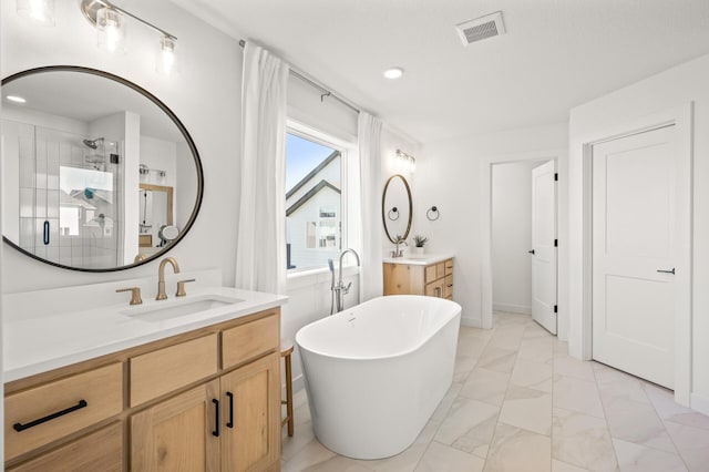 4429 Arbor Dr, Woodbury, MN 55129 - bathroom with marble finish flooring, two vanities, a freestanding bath, a shower stall, and recessed lighting