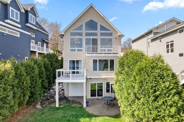 4101 Highwood Rd, Orono, MN 55364 - back of house featuring a balcony and a patio area
