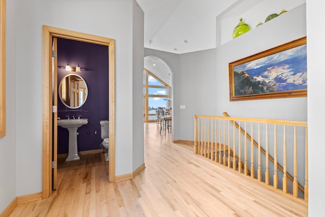 4101 Highwood Rd, Orono, MN 55364 - corridor featuring baseboards, arched walkways, hardwood / wood-style floors, and an upstairs landing