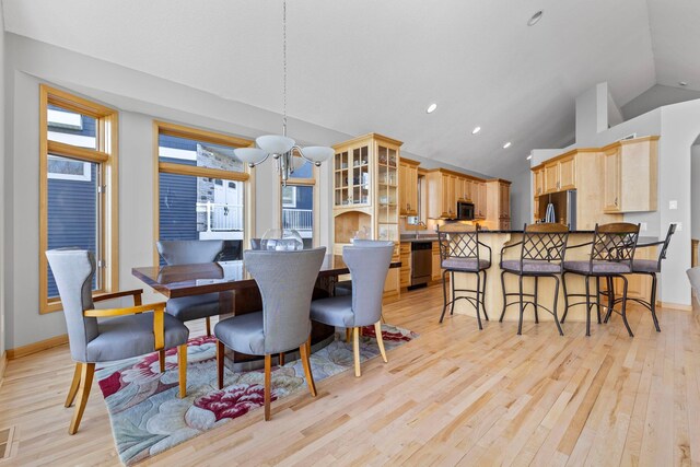 4101 Highwood Rd, Orono, MN 55364 - dining space featuring baseboards, high vaulted ceiling, a notable chandelier, light wood-style floors, and recessed lighting