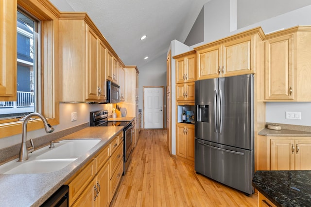 4101 Highwood Rd, Orono, MN 55364 - kitchen with light brown cabinetry, appliances with stainless steel finishes, a sink, lofted ceiling, and light wood-type flooring