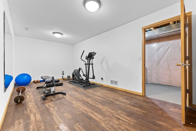 4101 Highwood Rd, Orono, MN 55364 - exercise room featuring baseboards, a textured ceiling, visible vents, and wood finished floors