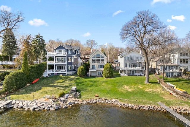 4101 Highwood Rd, Orono, MN 55364 - back of house with a balcony, a water view, a lawn, and a residential view