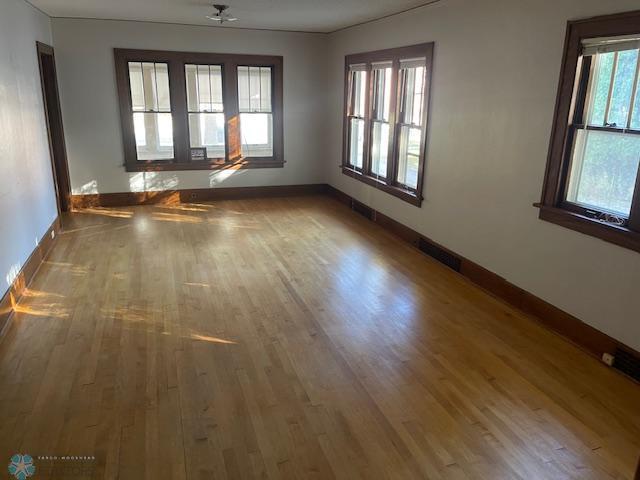 1326 9th Ave S, Fargo, ND 58103 - empty room with baseboards, wood finished floors, and visible vents