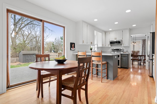 dining area with recessed lighting and light wood finished floors