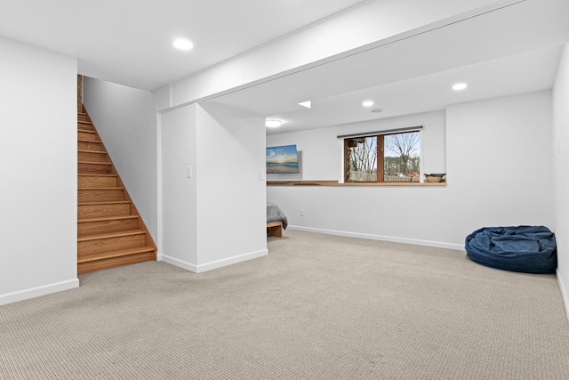 below grade area featuring baseboards, carpet flooring, stairs, and recessed lighting