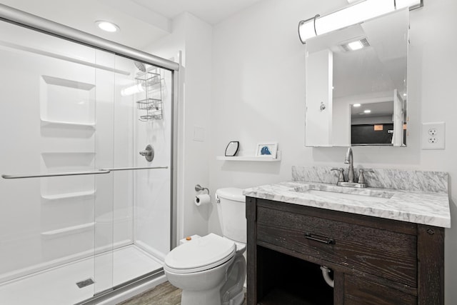 full bath with vanity, toilet, recessed lighting, a shower stall, and visible vents