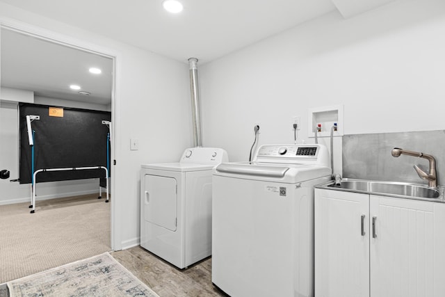 clothes washing area featuring recessed lighting, a sink, cabinet space, and washing machine and clothes dryer