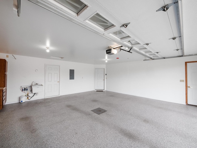 garage featuring electric panel and a garage door opener