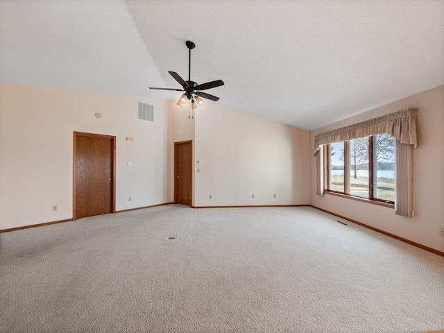 spare room featuring light colored carpet, ceiling fan, baseboards, and visible vents