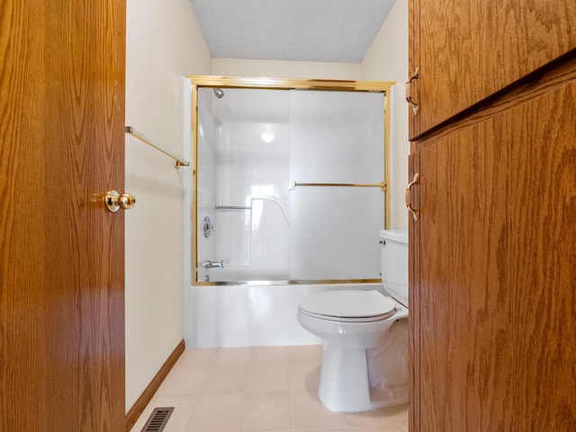 full bathroom featuring tile patterned floors, a textured ceiling, toilet, visible vents, and combined bath / shower with glass door