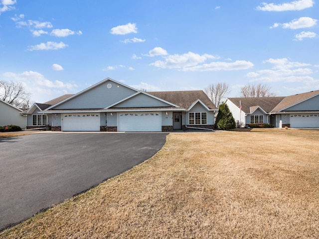 ranch-style house featuring a garage, driveway, and a front yard