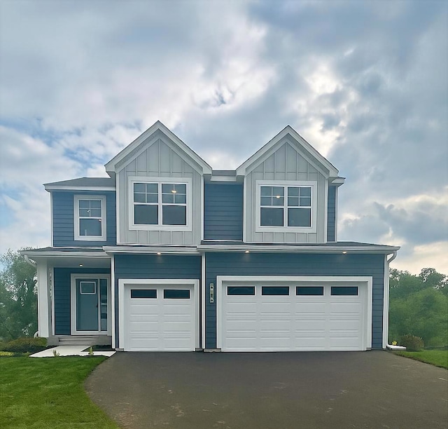 7881 Austin Way, Inver Grove Heights, MN 55077 - view of front facade with driveway, an attached garage, and board and batten siding