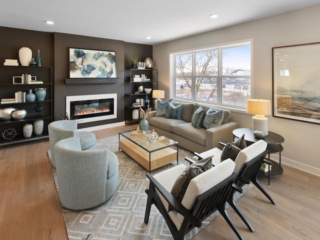 7881 Austin Way, Inver Grove Heights, MN 55077 - living area with a glass covered fireplace, wood finished floors, and recessed lighting