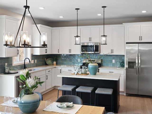 7881 Austin Way, Inver Grove Heights, MN 55077 - kitchen with stainless steel appliances, light countertops, light wood-type flooring, white cabinetry, and recessed lighting